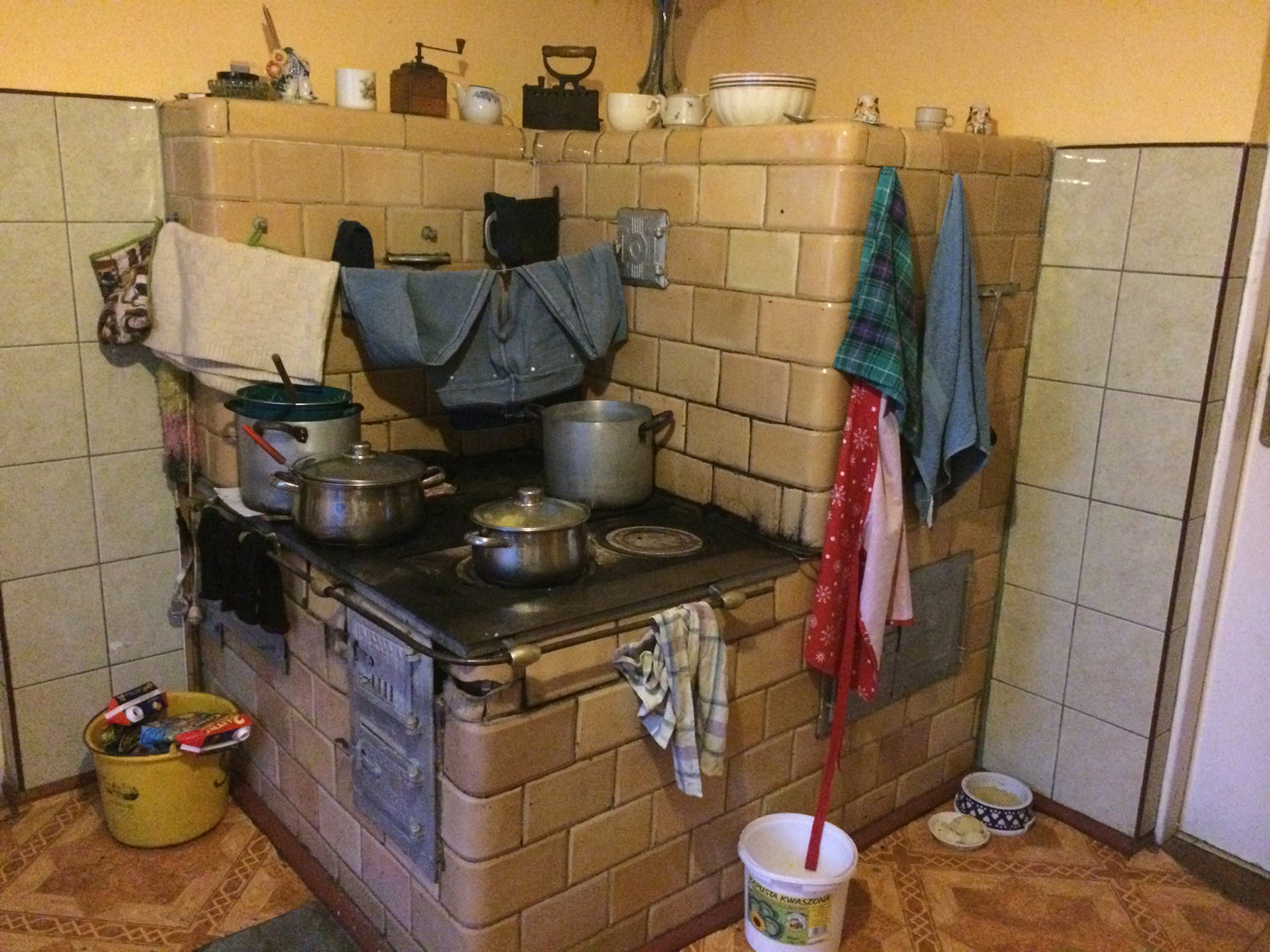 polish brick oven with cooking pans and laundry on display